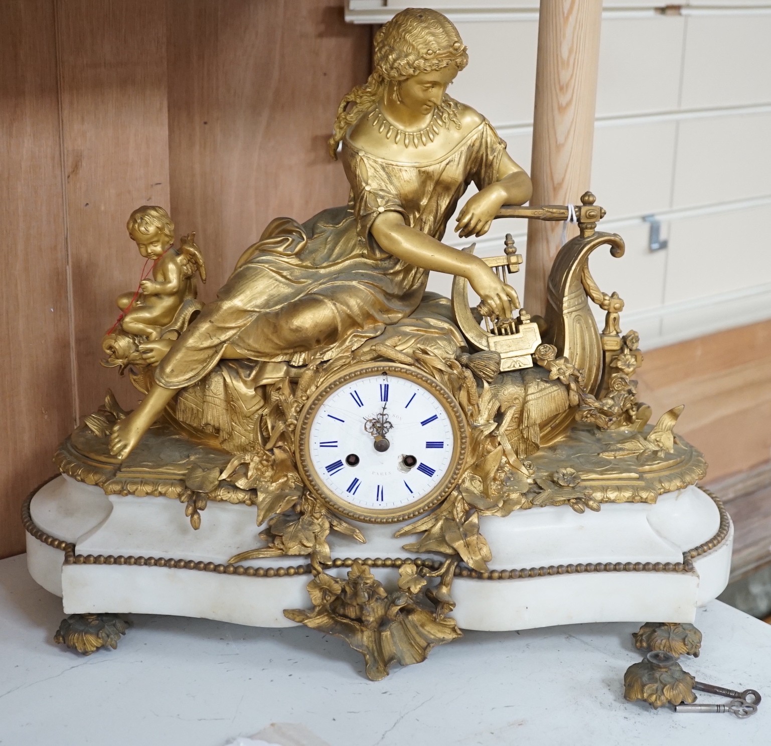 A 19th century French neoclassical revival figural ormolu and white marble clock, 39cm tall